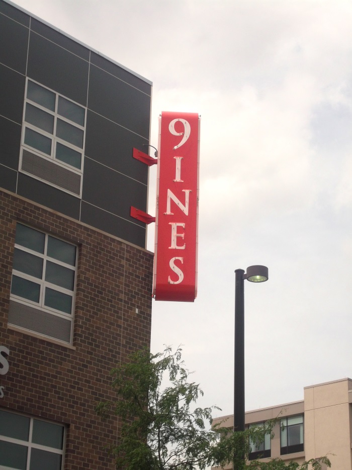 Neon illuminated 9ines projecting sign across from TD Ameritrade Park