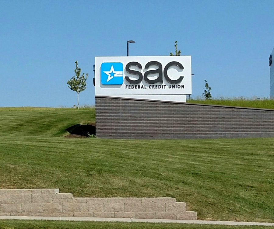 Illuminated, single-face SAC Federal Credit Union monument sign on the northwest elevation of their Papillion location